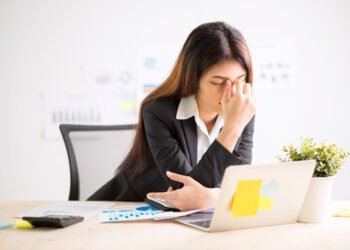 Young,Businesswoman,Doing,Exercises,At,Workplace,To,Relieve,Tired,Of